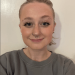 Young woman with pulled back hair and wearing a greyish sweatshirt