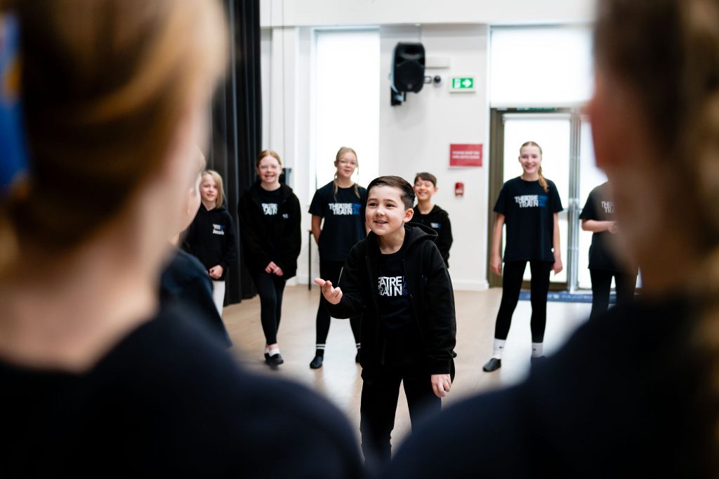 Young people smiling together at Theatretrain, building confidence, belonging and self-belief.