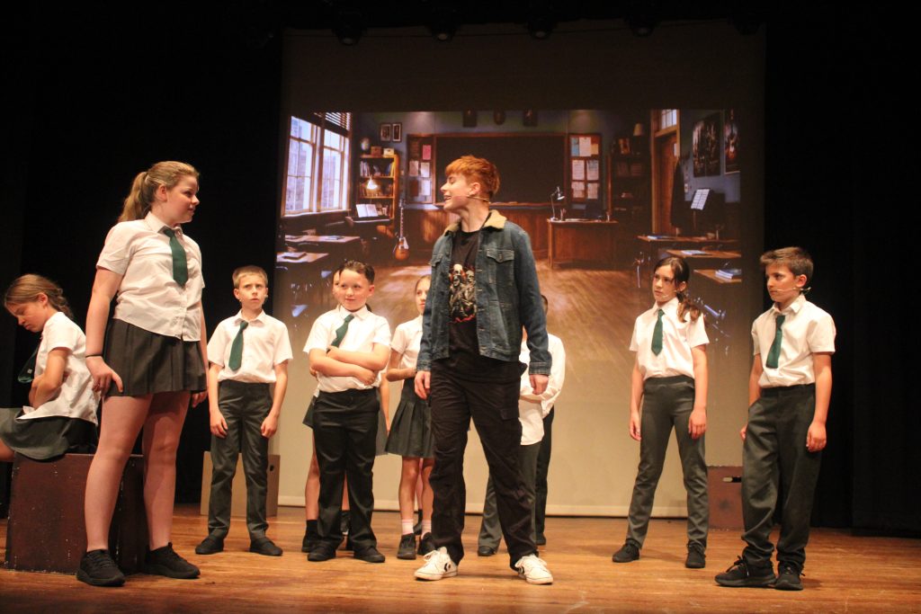 Children rehearsing together in a Theatretrain performing arts class, developing teamwork and confidence.