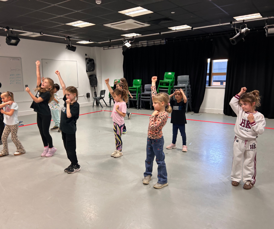 Theatretrain Letchworth Blog and Events 2 A child standing at the back of a performing arts class before gradually building the confidence to join in.